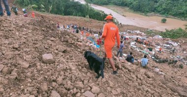 This photograph provided by India's National Disaster Response Force (NDRF) shows NDRF personnel and others trying to rescue those buried under the debris after a mudslide in Noney, northeastern Manipur state, India, June 30, 2022. (National Disaster Reponse Force via AP)