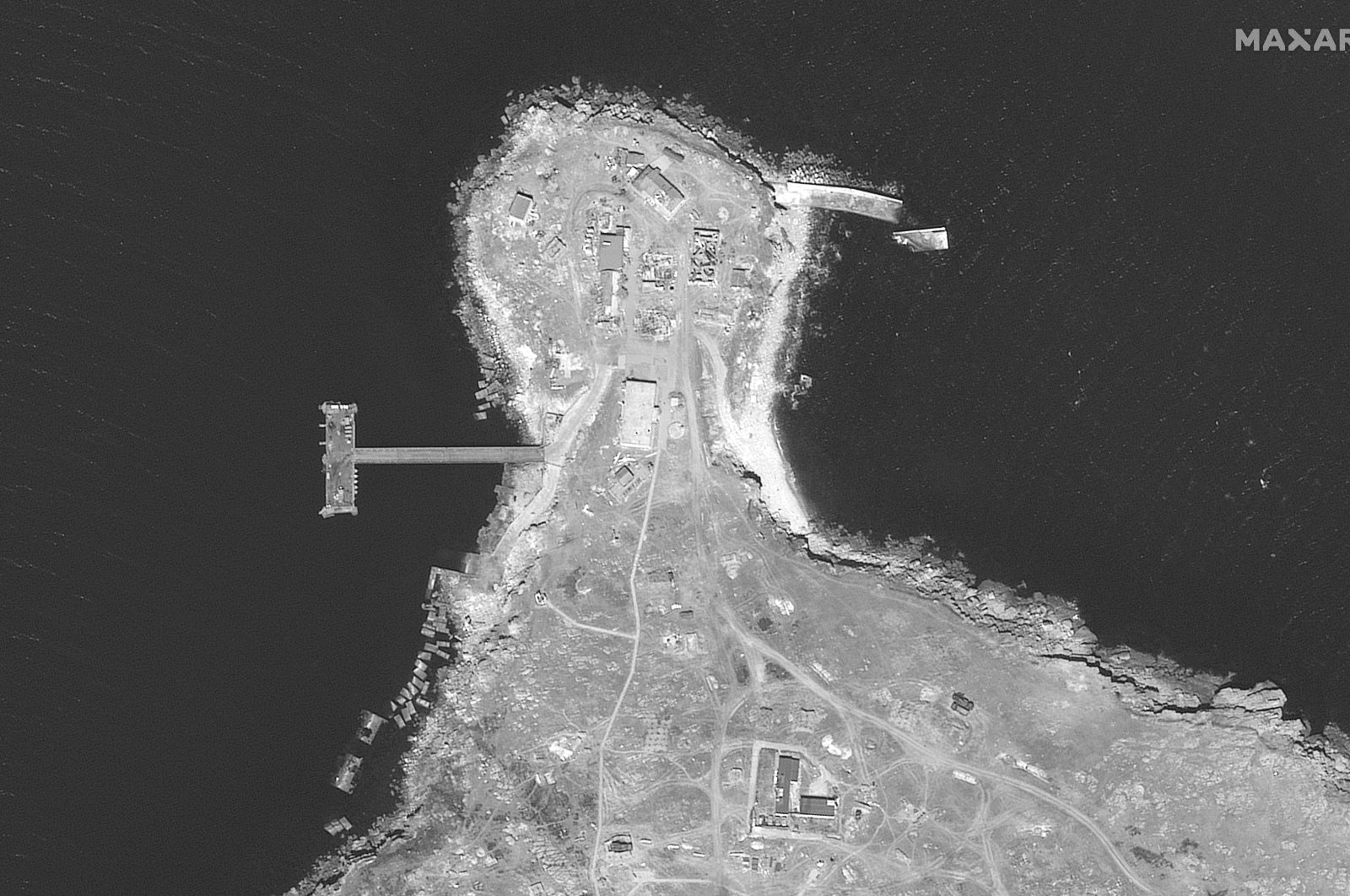 This WorldView-1 satellite black and white image from Maxar Technologies shows an overview of the northern end of Snake Island, in the Black Sea, June 17, 2022. (Satellite image ©2022 Maxar Technologies via AP)
