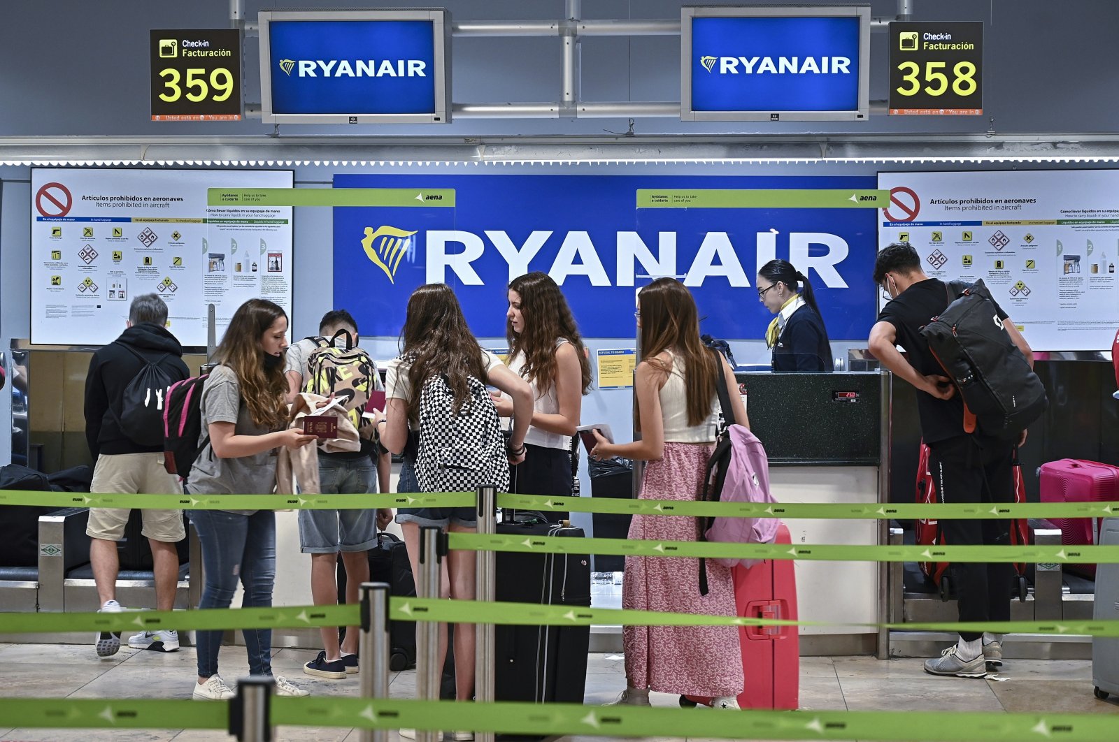Travelers wait near a Ryanair check-in desk during the first day of a strike called by Ryanair crew, at Adolfo Suarez Madrid Barajas International Airport, in Madrid, Spain, June 24, 2022. (EPA Photo)