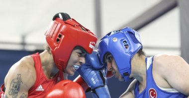 National boxer Busenaz Sürmeneli (R) competes against Italian rival Melissa Gemini (L) in the women&#039;s 66 kg semi-final match at  the Mediterranean Games in Algeria, July 1, 2022. (AA Photo)