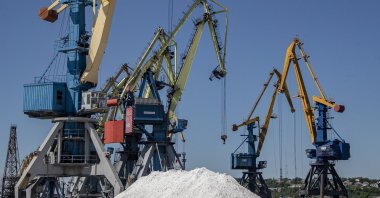 A picture taken during a visit to Mariupol organized by the Russian military shows a Russian serviceman stands guard in the cargo sea port of Mariupol, Ukraine, June 12, 2022. (EPA Photo)