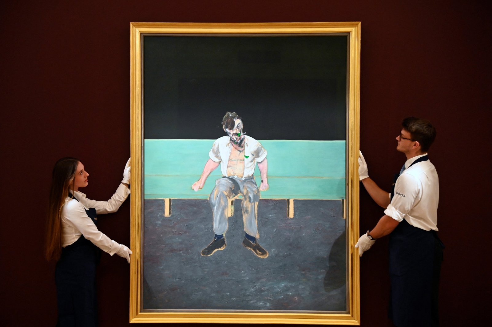 Technicians pose with &quot;Study for Portrait of Lucian Freud&quot; by Francis Bacon which forms part of the upcoming &quot;British Art: The Jubilee Auction&quot; event at Sotheby&#039;s, in London, Britain, June 22, 2022.(REUTERS)