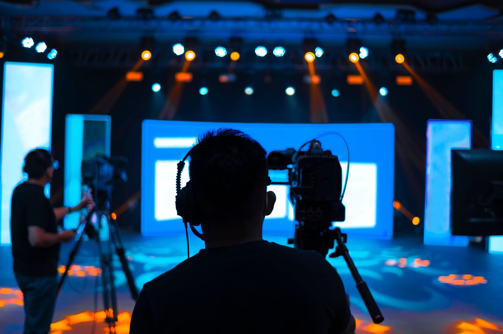 A camera operator covering an event on live studio news. (Shutterstock)