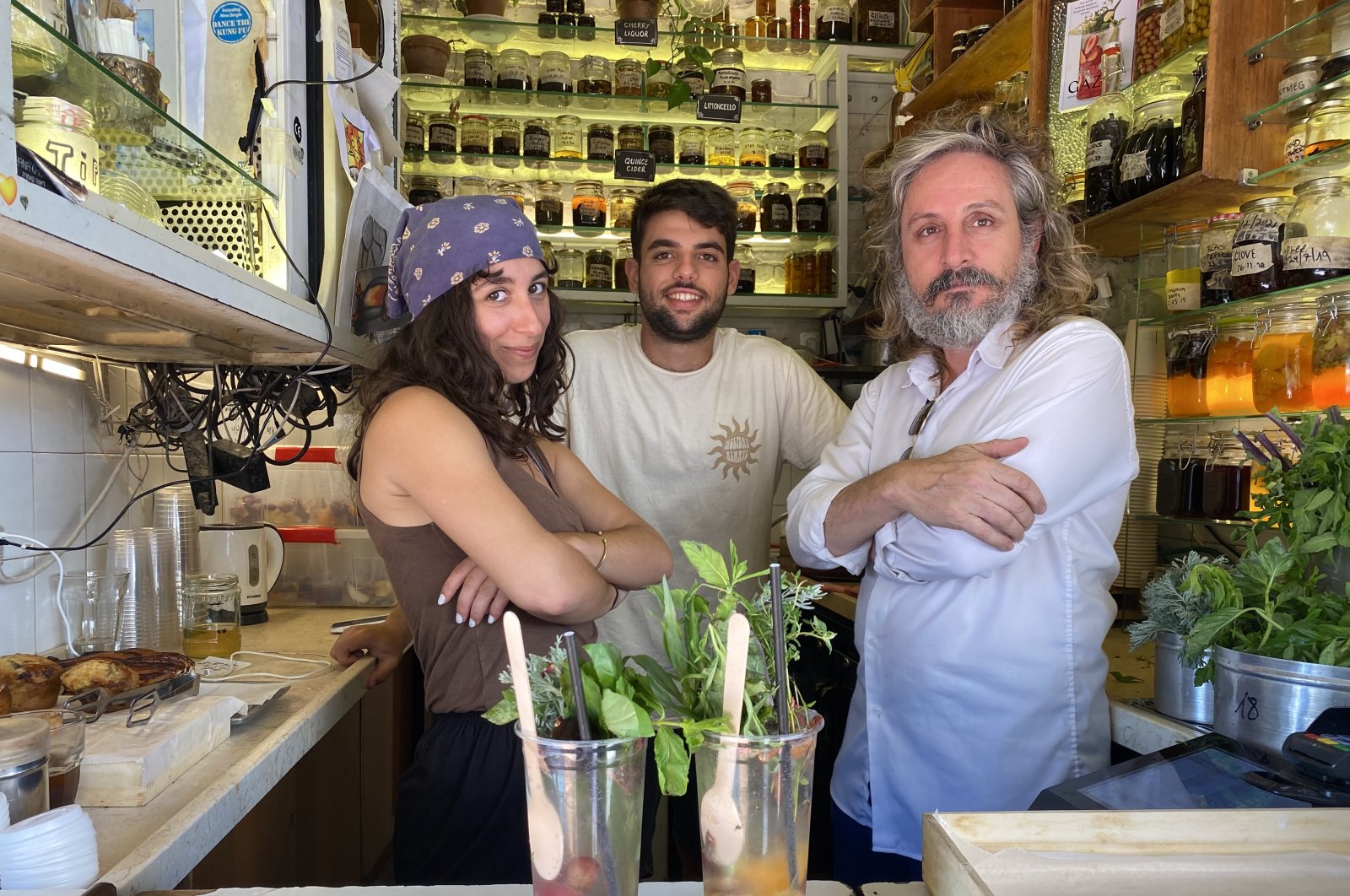 Israeli Benny Briga (r) in his kiosk, with his staff Eden (l) and Omri prepared the drink Gazoz in their kiosk at Levinsky Market, Tel Aviv, Israel, June 14, 2022. (DPA Photo)