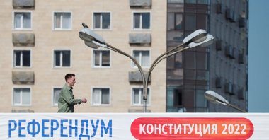 A man walks along a bridge near a banner informing of the upcoming referendum in Almaty, Kazakhstan, June 1, 2022. (Reuters Photo)