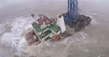 In this image released by Hong Kong Government Flying Service, a helicopter with rescue crew members approaches a sinking ship in the South China Sea, 300 kilometers (186 miles) south of Hong Kong, July 2, 2022, as Typhoon Chaba was moving in the area. (Hong Kong Government Flying Service via AP)