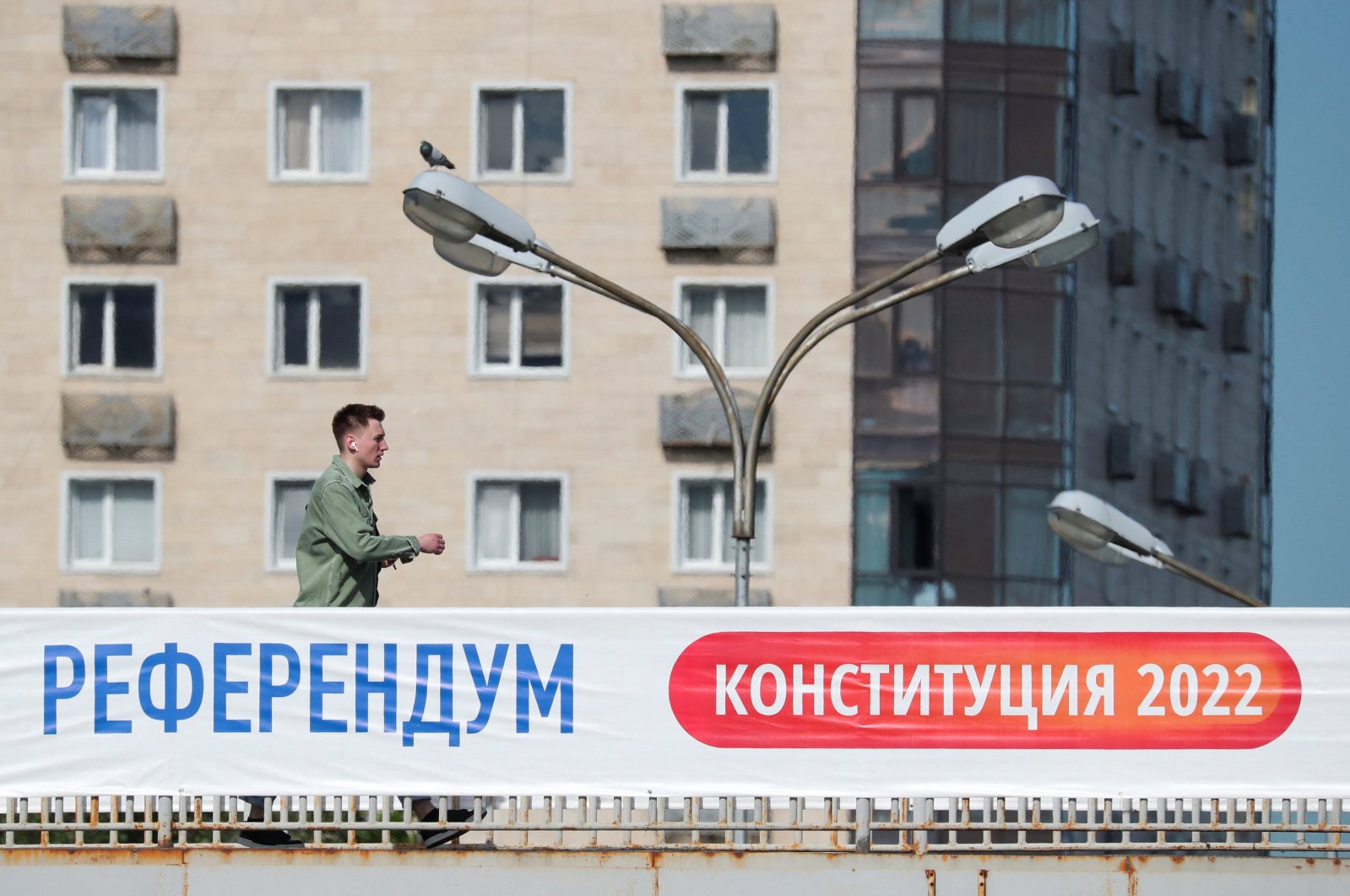 A man walks along a bridge near a banner informing of the upcoming referendum in Almaty, Kazakhstan, June 1, 2022. (Reuters Photo)