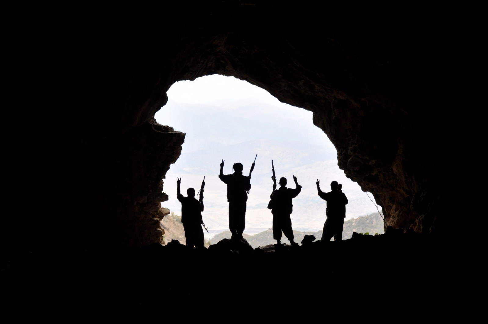 PKK terrorists pose in the mouth of a cave at an undisclosed location in this undated photo. (Alamy Photo via Reuters)