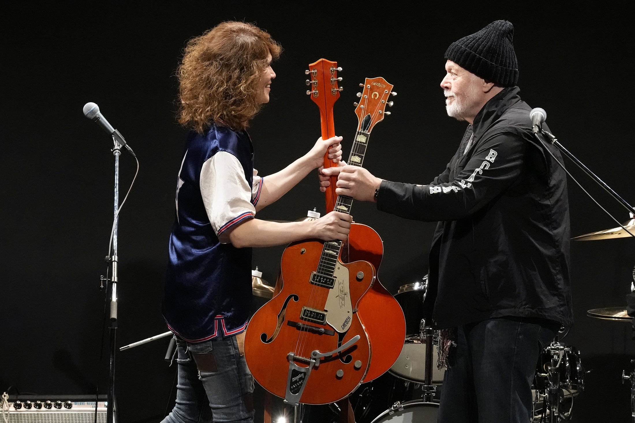 Canadian rock legend Randy Bachman (R), receives his stolen Gretsch guitar during the Lost and Found Guitar Exchange Ceremony, at Canadian Embassy in Tokyo, Japan, July 1, 2022. (AP Photo)