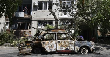 A destroyed car lies next to an apartment building damaged by an overnight missile strike in Slovyansk, Ukraine, May 31, 2022. (AP Photo)