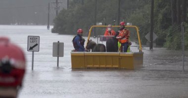 An emergency crew rescues two ponies from a flooded area in Milperra, Sydney metropolitan area, Australia, July 3, 2022 in this screen grab obtained from a handout video. (Reuters Photo)