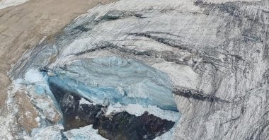A handout photo from Alpine rescue services shows where an ice glacier collapsed on Marmolada mountain, Italy, July 3, 2022. (Reuters Photo)