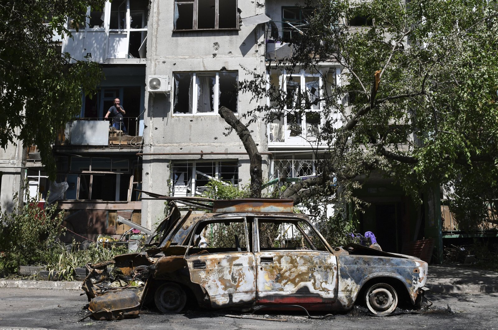 A destroyed car lies next to an apartment building damaged by an overnight missile strike in Slovyansk, Ukraine, May 31, 2022. (AP Photo)