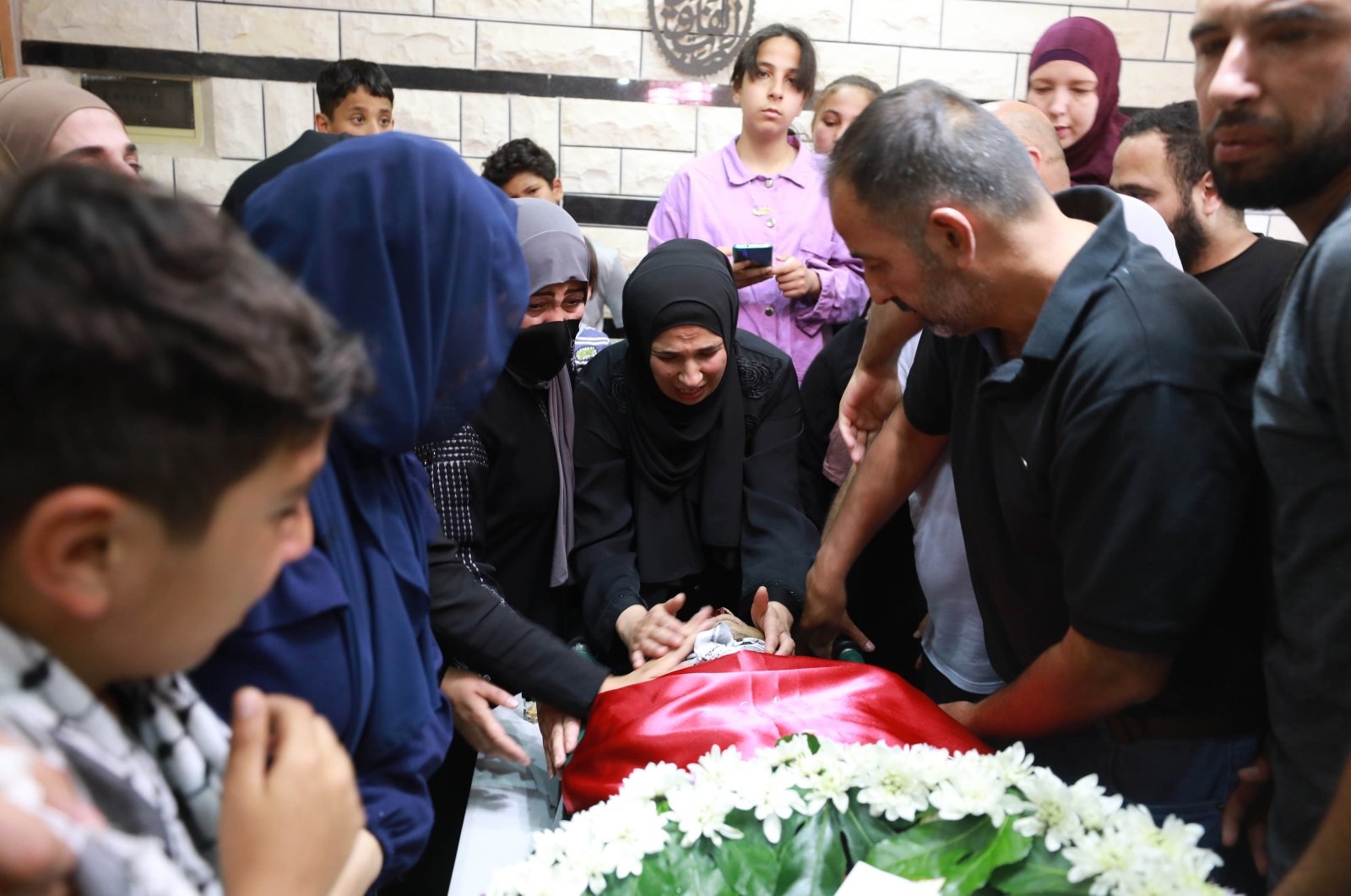 Relatives mourn at the funeral for another Palestinian teen who died as a result of Israeli fire, 16-year-old Mohammed Abdullah Hamid, in the occupied West Bank, Palestine, June 30, 2022. (AA Photo)