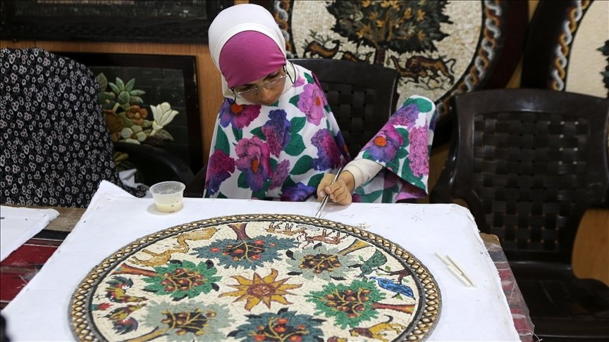 Rahma Khairallah poses while making a mosaic panel, Mosaic House for Crafts and Handicrafts , Madaba, Jordan, June 28, 2022. (AA) 