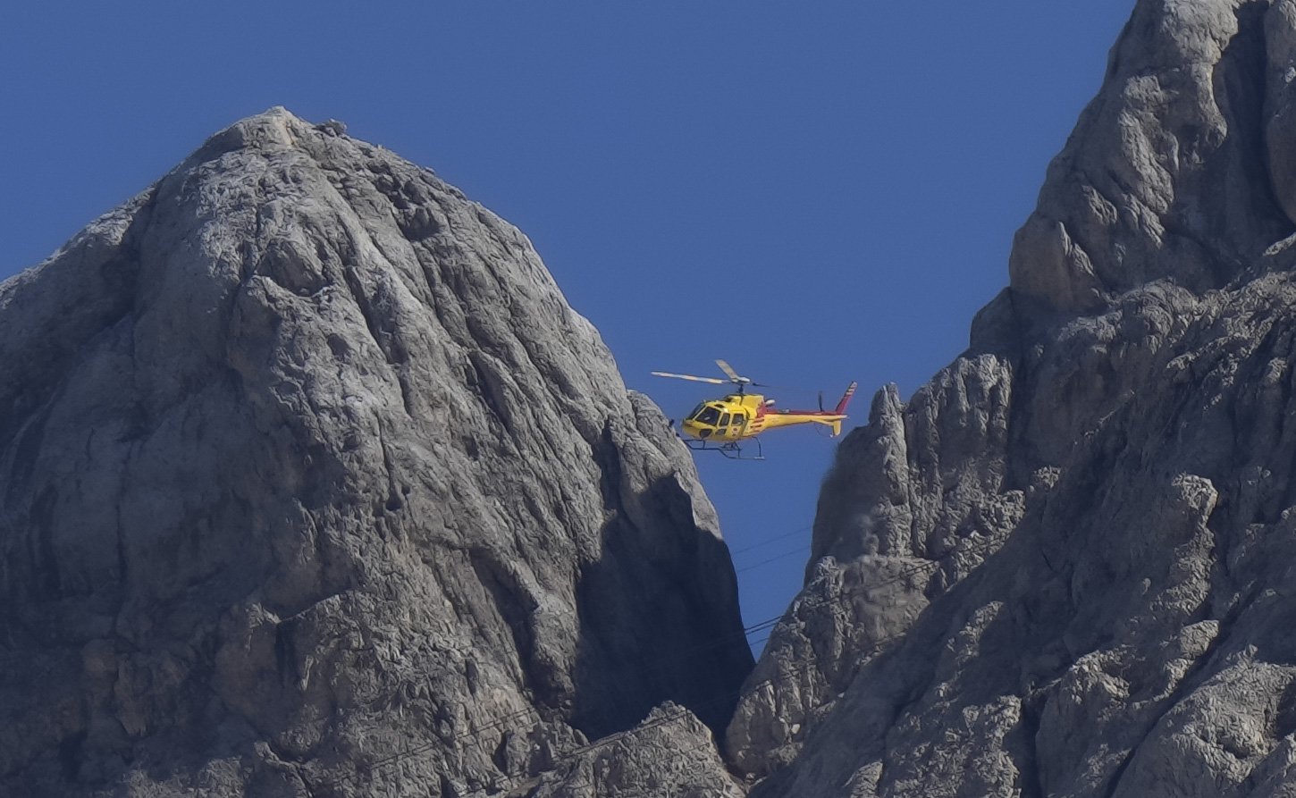 A rescue helicopter hovers over the Punta Rocca glacier near Canazei, in the Italian Alps in northern Italy,  a day after a huge chunk of the glacier broke loose, sending an avalanche of ice, snow and rocks onto hikers, July 4, 2022. (AP Photo)