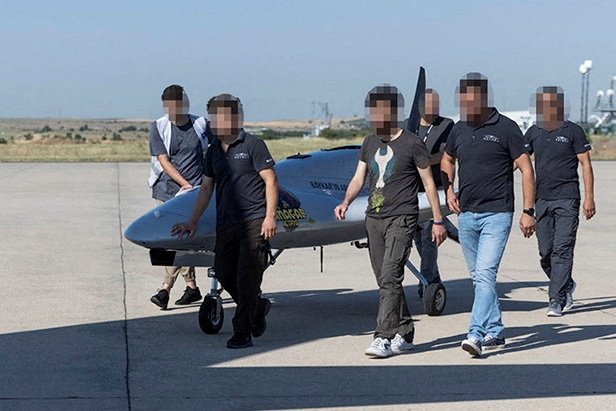 People walk next to the crowdfunded Bayraktar TB2 combat drone destined for Ukraine as it is delivered to Lithuania, in this undated handout image provided on July 4, 2022. (Lithuanian Ministry of Defense via Reuters)
