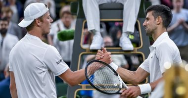 Novak Djokovic (R) greets Tim van Rijthoven (L) during their Wimbledon men's fourth-round match, Wimbledon, England, July 3, 2022. (EPA Photo)