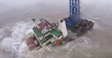 A helicopter with rescue crew members approaches a sinking ship in the South China Sea, 300 kilometers (186 miles) south of Hong Kong, July 2, 2022. (Hong Kong Government Flying Service via AP)