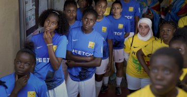 Players wait before entering the field prior to the final women's game of the national cup of working-class neighborhoods between a team representing players with Malian heritage against one with Congolese roots, in Creteil, France, July 2, 2022. (AP Photo)