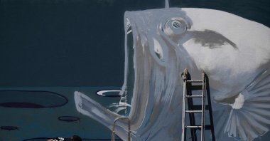 Portuguese graffiti and visual artist Goncalo Mar works on a mural symbolizing the defense of the deep ocean, in Lisbon, Portugal, July 1, 2022. (AFP Photo)