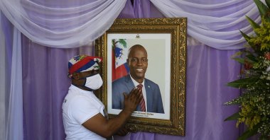 A man touches the portrait of the late Haitian President Jovenel Moise, in Cap-Haitien, Haiti, July 22, 2021. (AP PHOTO)