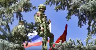 Russian soldiers set the national flag and a replica of the victory banner a top of the administration after capturing the eastern village of Bilohorivka which is now a territory under the Government of the Luhansk People&#039;s Republic control, eastern Ukraine, July 3, 2022. (Russian Defense Ministry Press Service via AP)