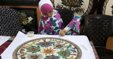 Rahma Khairallah poses while making a mosaic panel, Mosaic House for Crafts and Handicrafts , Madaba, Jordan, June 28, 2022. (AA) 