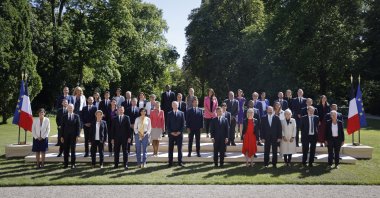 French President Emmanuel Macron (C) poses with ministers in the gardens of the Elysee Palace in Paris, France, July 4, 2022. (AP Photo)