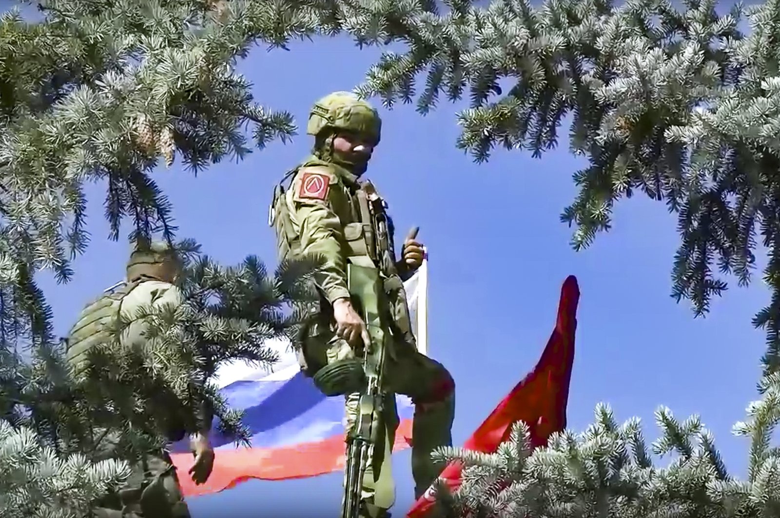 Russian soldiers set the national flag and a replica of the victory banner a top of the administration after capturing the eastern village of Bilohorivka which is now a territory under the Government of the Luhansk People&#039;s Republic control, eastern Ukraine, July 3, 2022. (Russian Defense Ministry Press Service via AP)