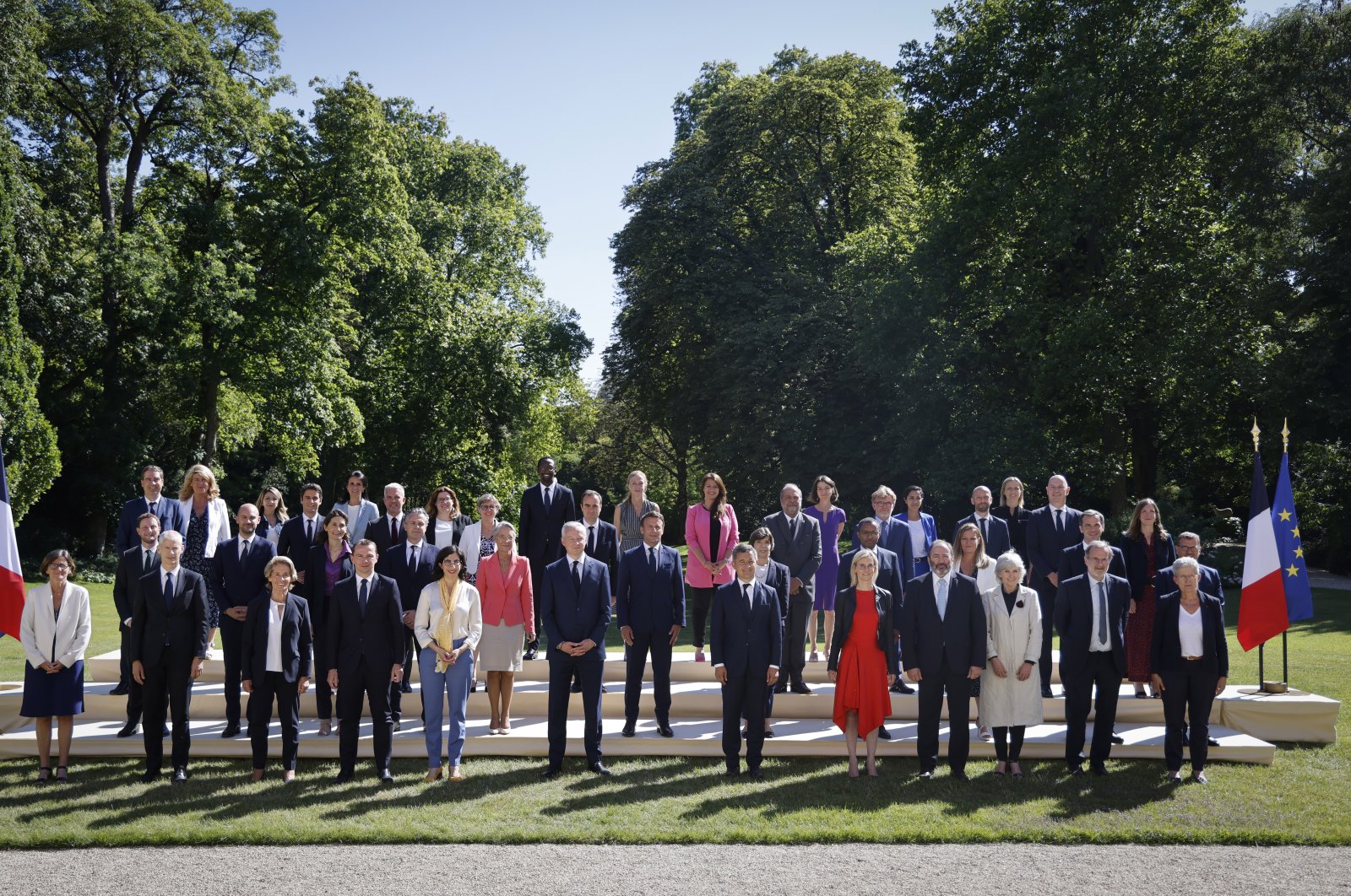 French President Emmanuel Macron (C) poses with ministers in the gardens of the Elysee Palace in Paris, France, July 4, 2022. (AP Photo)