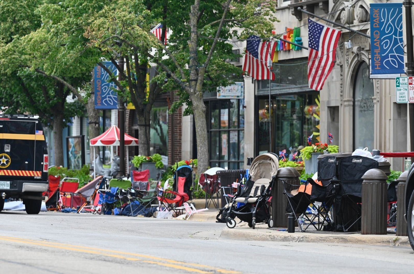 Empty chairs sit along the sidewalk after parade-goers fled Highland Park&#039;s Fourth of July parade after shots were fired, Chicago, Illinois, U.S., July 4, 2022. (Tyler Pasciak LaRiviere/Chicago Sun-Times via AP)