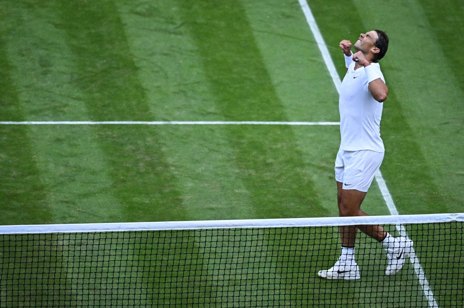 Spain&#039;s Rafael Nadal celebrates beating Netherlands&#039; Botic Van De Zandschulp during their round of 16 men&#039;s singles tennis match on the eighth day of the 2022 Wimbledon Championships at The All England Tennis Club in Wimbledon, southwest London, July 4, 2022. (AFP Photo)
