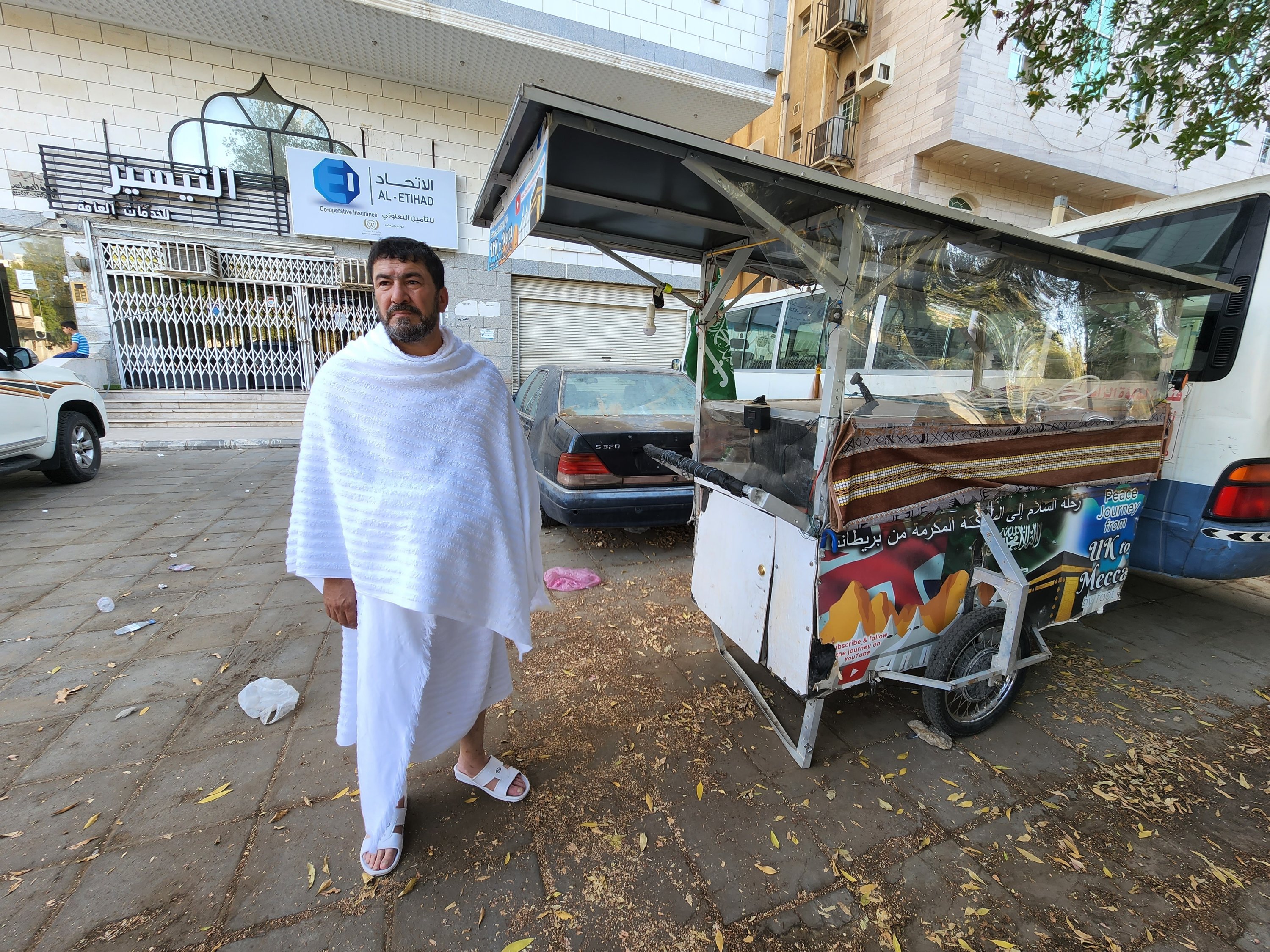 Adam Muhammed standing next to his cart that he pushed on the "Peace Journey" all the way from England to Saudi Arabia undertaking the whole journey on foot, Mecca, Saudi Arabia, July 5, 2022. (AA Photo)