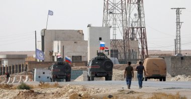 Russian and Syrian national flags flutter on military vehicles near Manbij, Syria, Oct. 15, 2019. REUTERS/Omar Sanadiki/File Photo