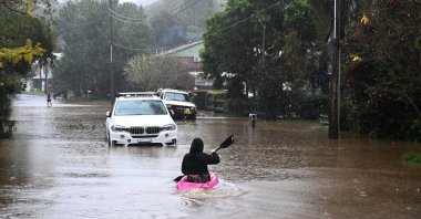 Children are seen on kayaks in floodwaters which have inundated the town of Yarramalong on the Central Coast, north of Sydney, Australia, July 5, 2022. (EPA Photo)