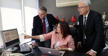 Professors Aylin Sepici Dinçel (C) and Altay Uludamar (L) and Dr. Erdal Ergunol (R) in their office, in the capital Ankara, Turkey, July 4, 2022. (AA PHOTO)