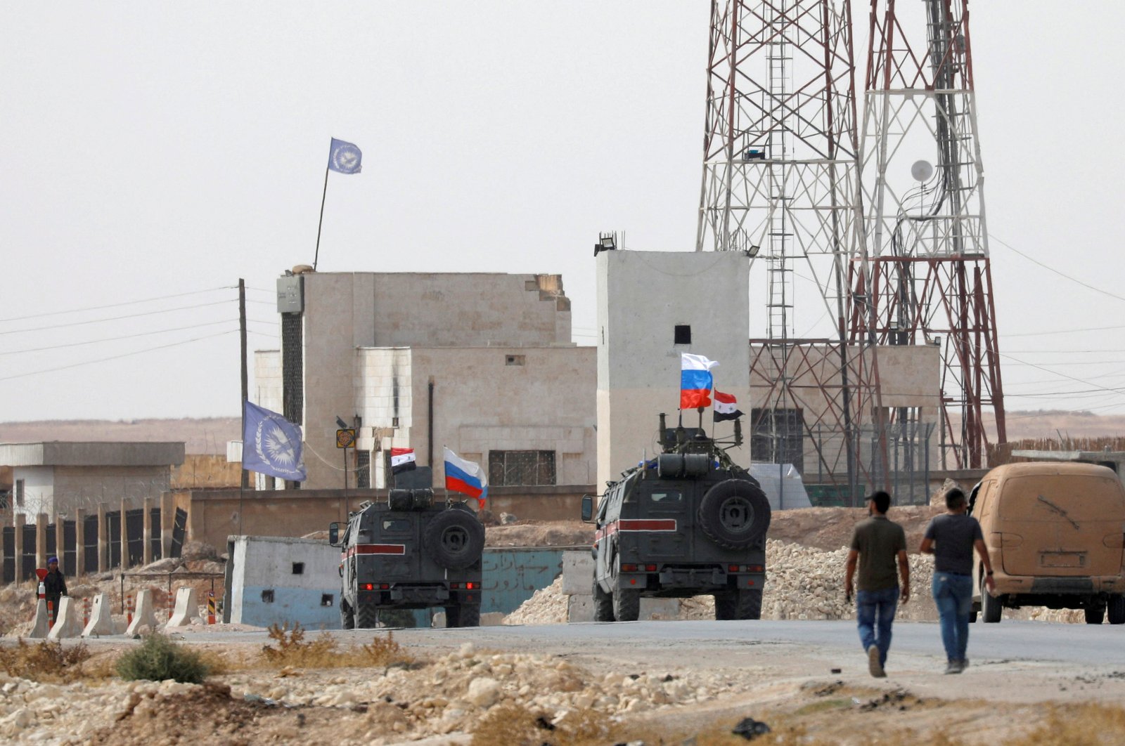 Russian and Syrian national flags flutter on military vehicles near Manbij, Syria, Oct. 15, 2019. REUTERS/Omar Sanadiki/File Photo