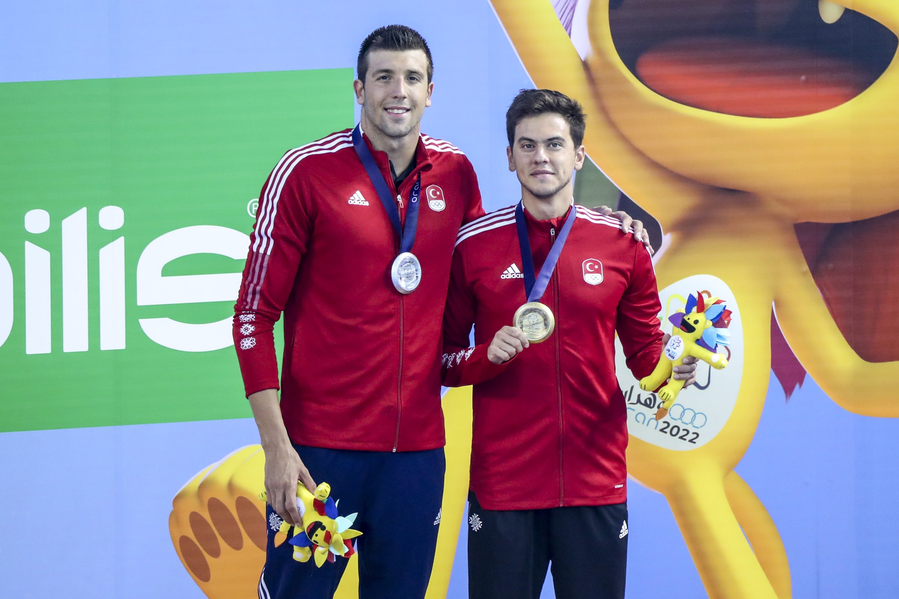 Berkay Ömer Öğretir (R) and Emre Sakçı celebrate after a one-two finish in the men's 100-meter breaststroke event at the Med Games, Oran, Algeria July 5, 2022. (AA Photo)