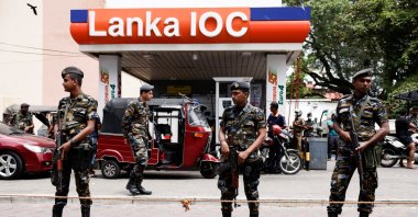 Air force members stand guard at a Lanka IOC fuel station (Indian Oil Corporation) as people queue up to buy fuel due to fuel shortage, amid the country's economic crisis, in Colombo, Sri Lanka, July 6, 2022. (Reuters Photo)