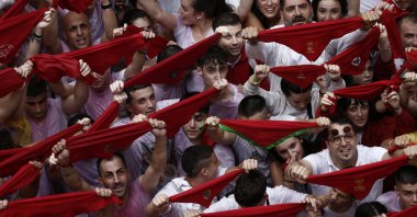 Revelers hold up the traditional red scarves at the Consistorial Square during the "chupinazo" that marks the beginning of the San Fermin Festival in Pamplona, Spain, July 6, 2022. (EPA Photo)