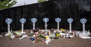 An American flag flies at half-staff near a memorial for the victims of a mass shooting at a Fourth of July parade, in Highland Park, Illinois, U.S., July 6, 2022. (AFP Photo)
