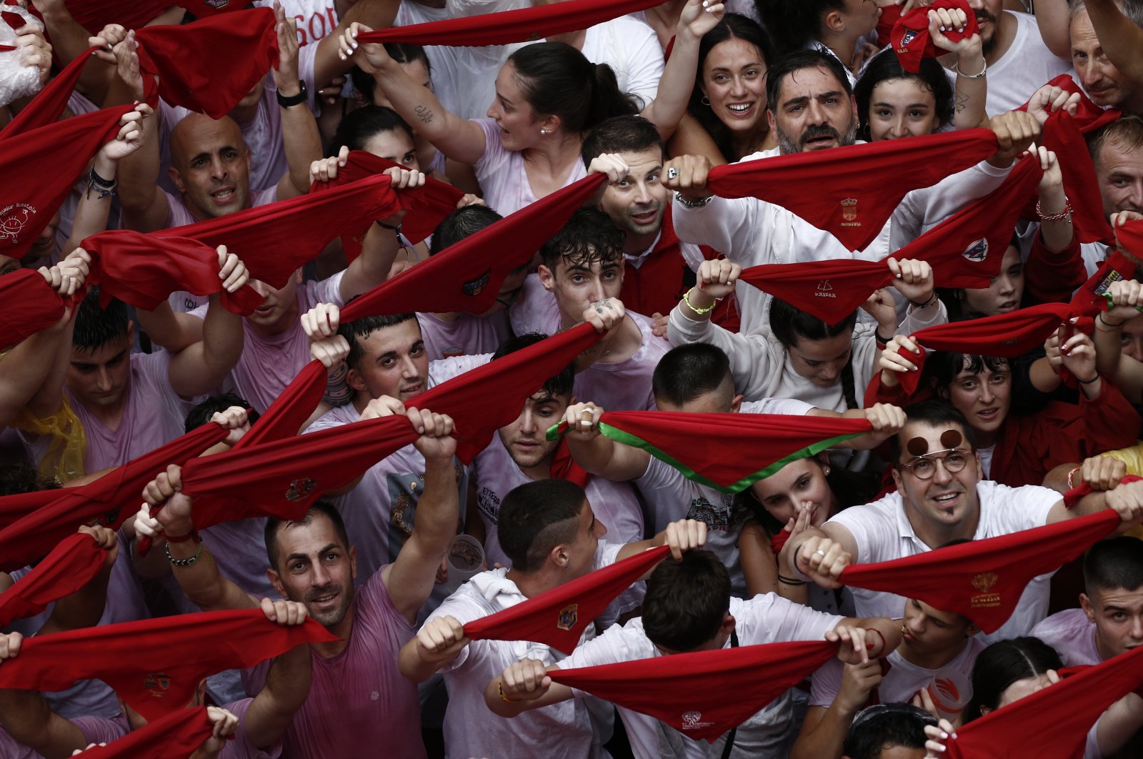 Revelers hold up the traditional red scarves at the Consistorial Square during the &quot;chupinazo&quot; that marks the beginning of the San Fermin Festival in Pamplona, Spain, July 6, 2022. (EPA Photo)