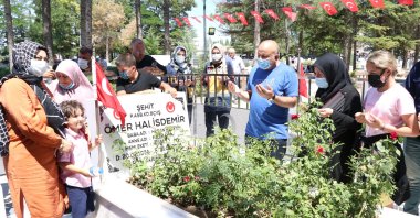 People recite prayers by the grave of Ömer Halisdemir, in Niğde, central Turkey, July 16, 2021. (AA PHOTO)