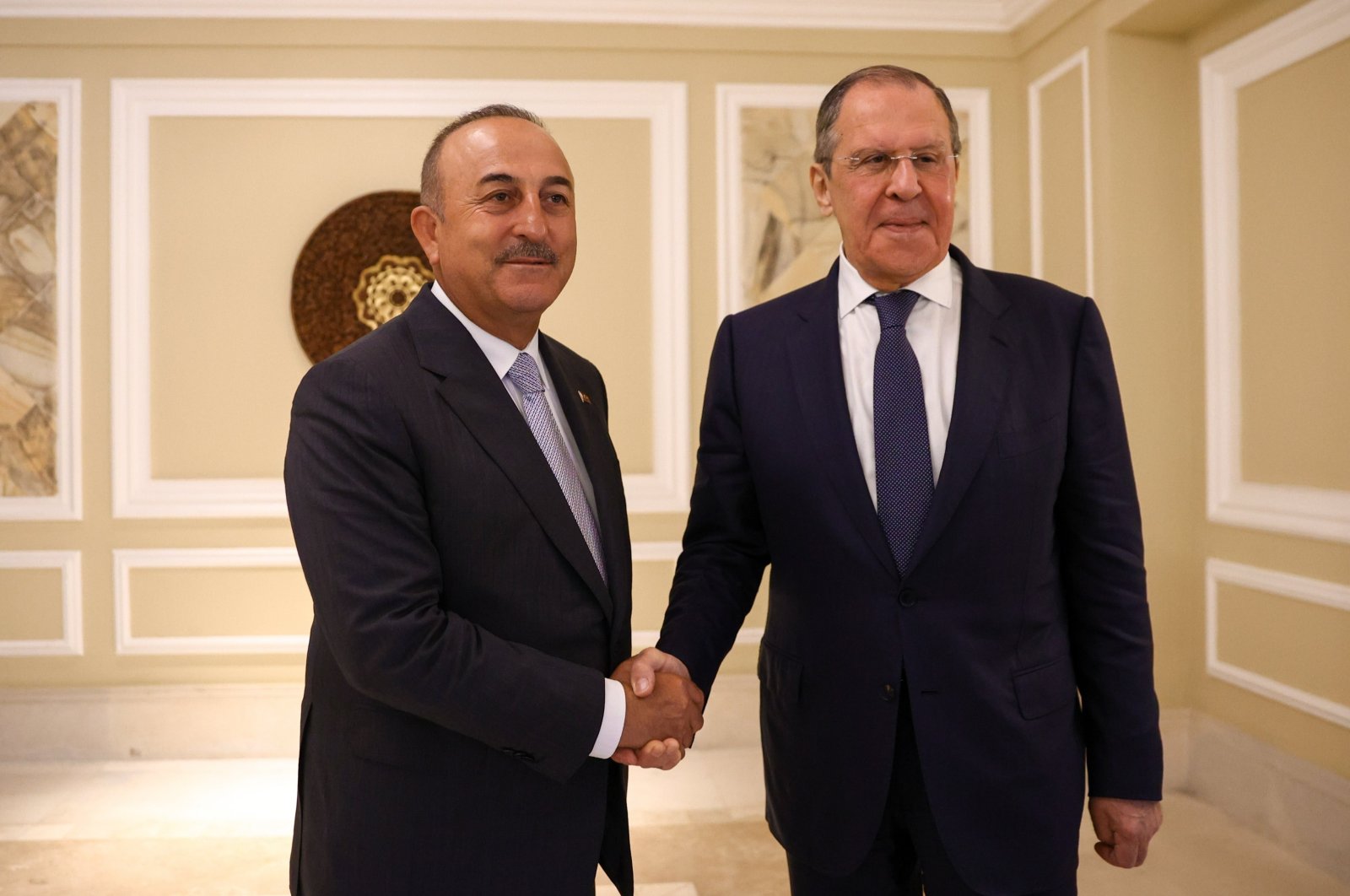 Foreign Minister Mevlüt Çavuşoğlu (L) and Russian Foreign Minister Sergey Lavrov shakes hands at a meeting in Indonesia, July 7, 2022. (IHA Photo)