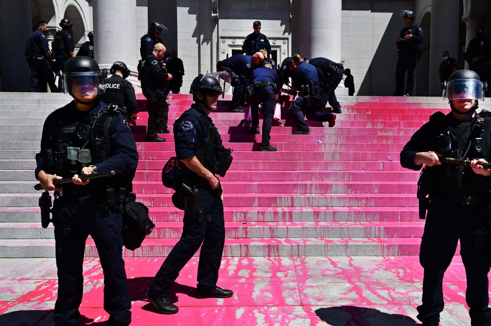 Police officers in riot gear stand near red paint splattered on the steps of City Hall as abortion-rights activists holding a protest to demand the government restore nationwide abortion rights are arrested, Los Angeles, California, U.S., July 6, 2022. (AFP Photo)