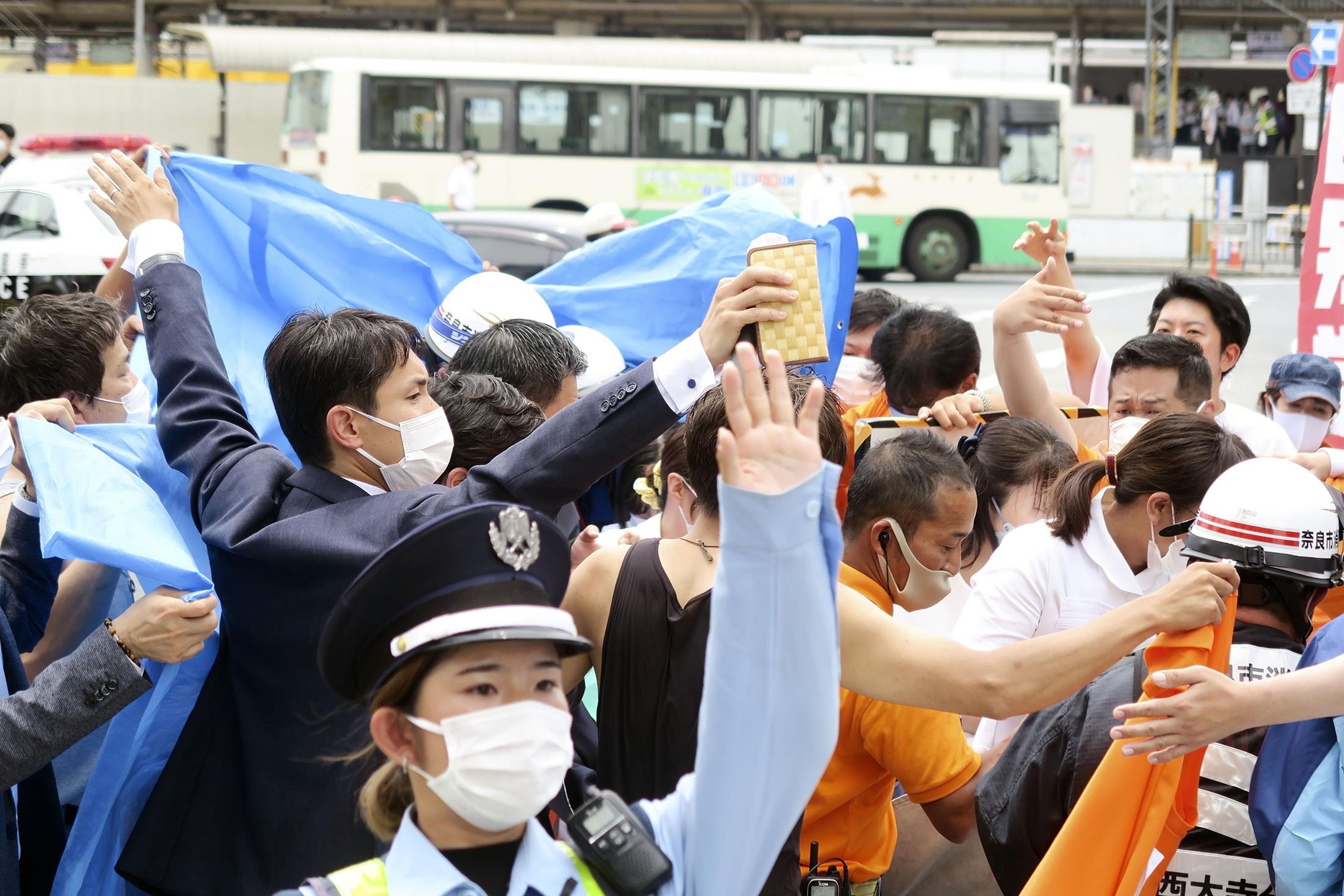 People react after gunshots in Nara, western Japan, July 8, 2022. (AP Photo)