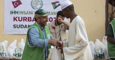 A volunteer from Turkish charity IHH delivers meat in Khartoum, Sudan, July 22, 2021. (Courtesy of IHH)