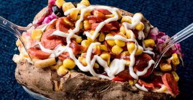 Kumpir, a baked potato topped with cheese, corn, sausage, ketchup and mayonnaise. (Shutterstock Photo)