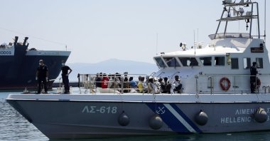 Migrants sit on the deck of a coast guard vessel upon their arrival at Mytilene port, on the northeastern Aegean Sea island of Lesbos, Greece, June 22, 2022. (AP Photo)